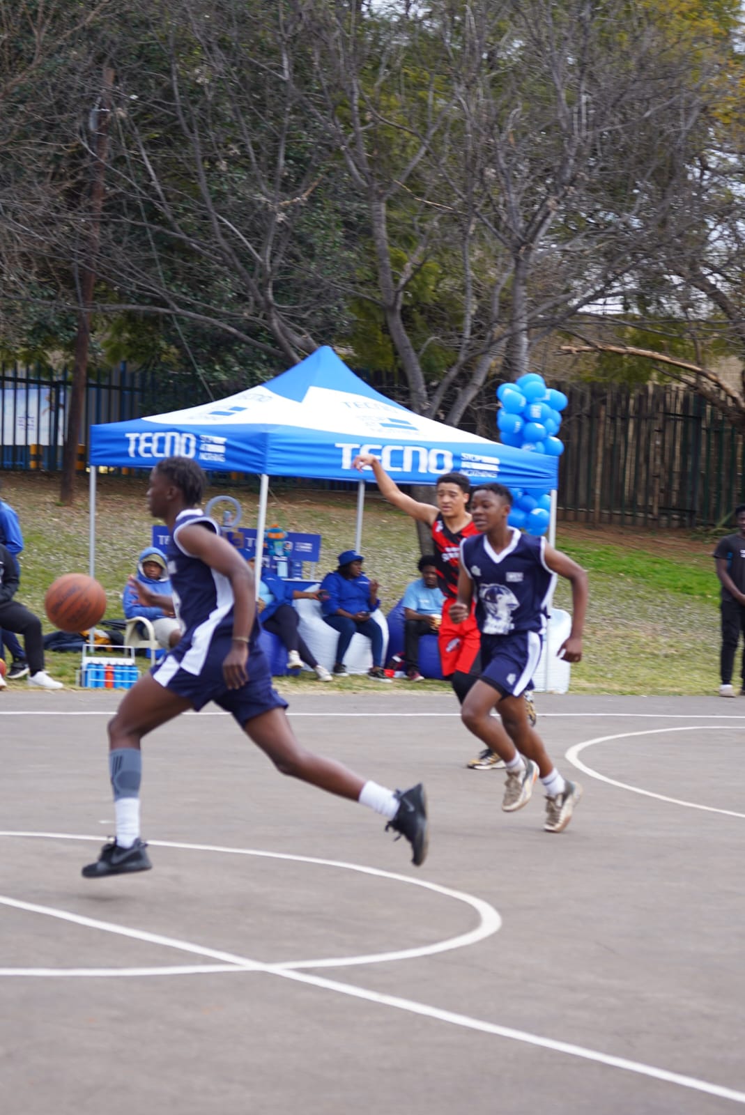 Players racing up the court during a tournament game